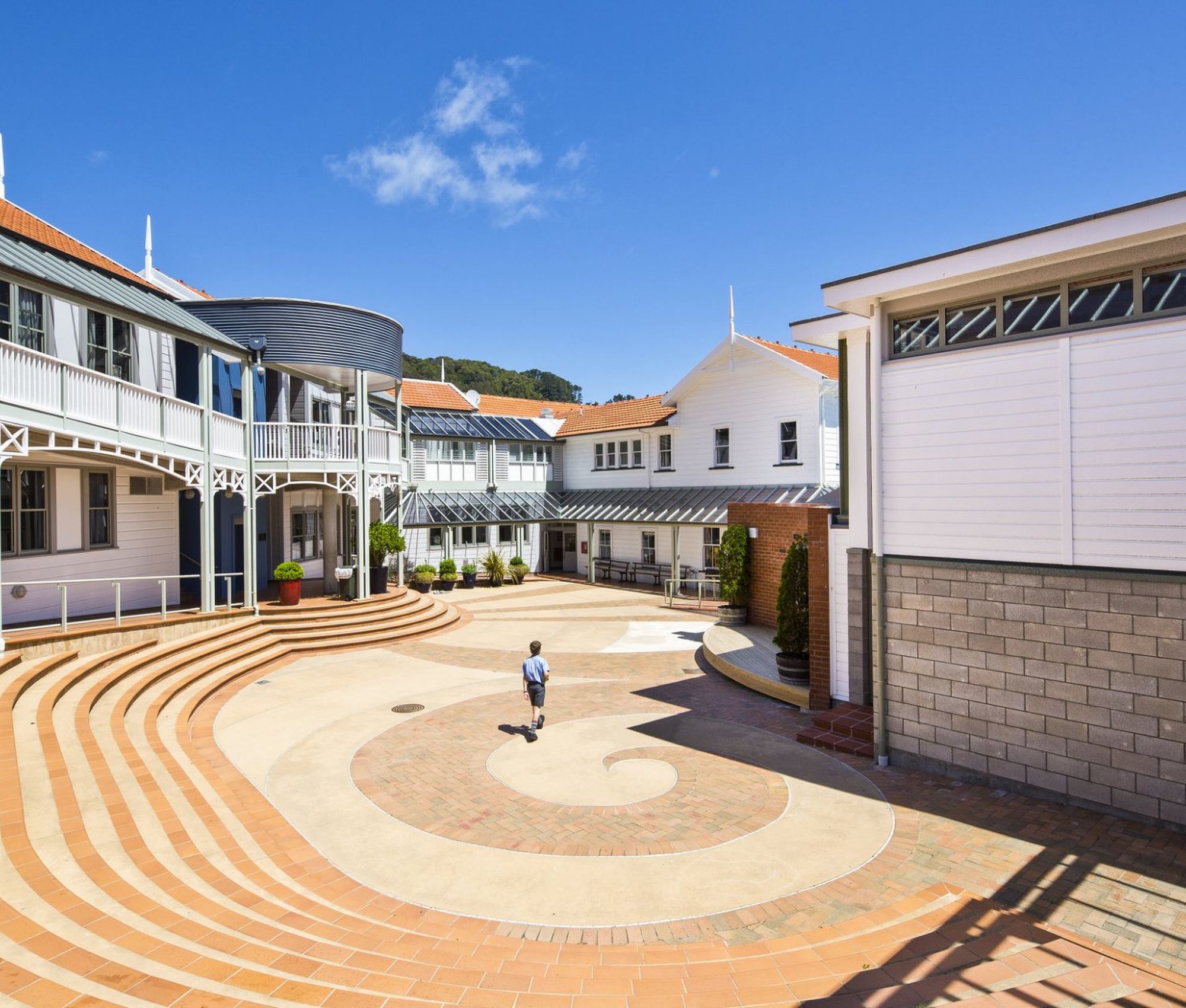 Wellesley College inner quad with surrounding school buildings, featuring paved pathways and student walking between classrooms