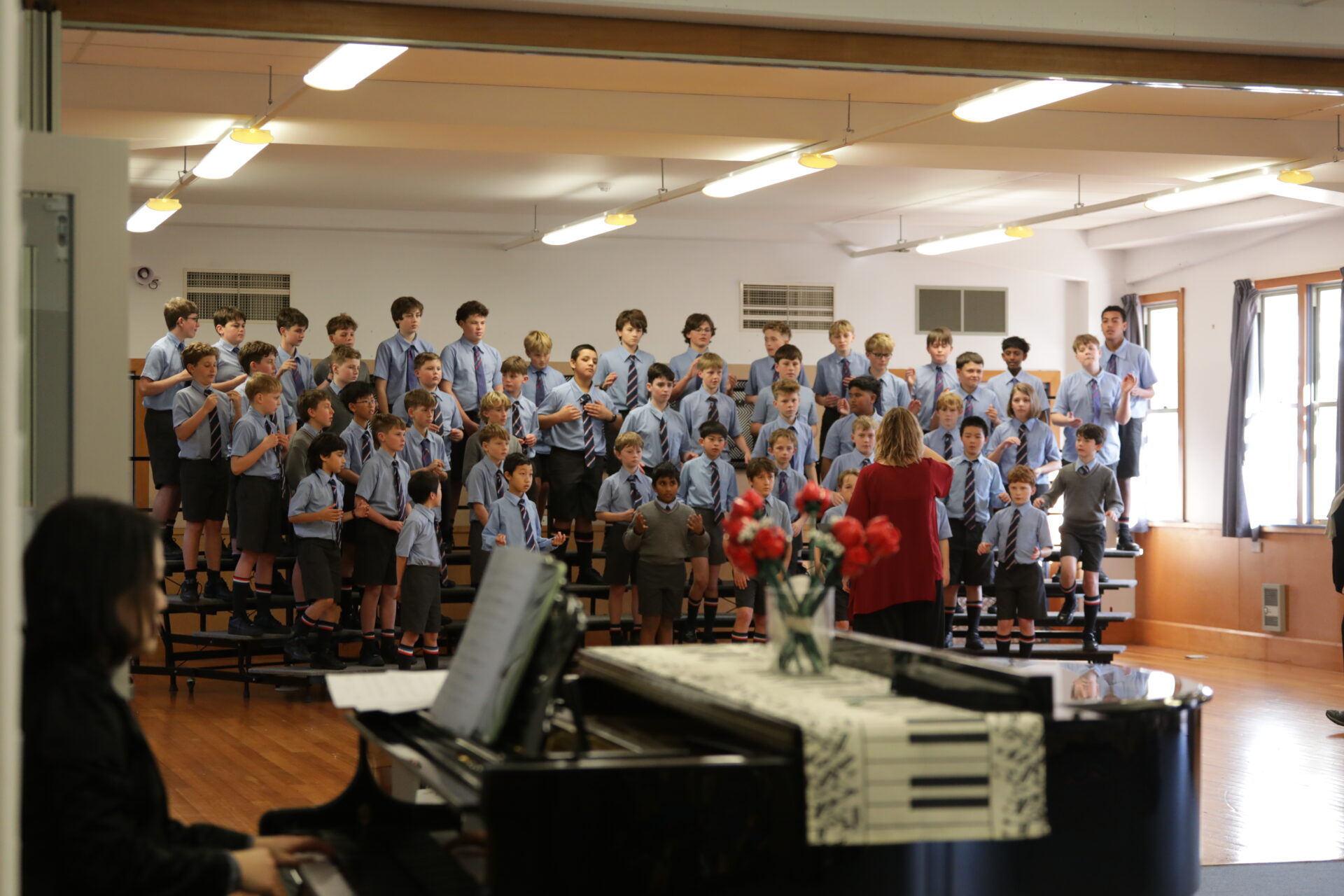 Wellesley College boys singing in the choir, standing in rows in their uniforms