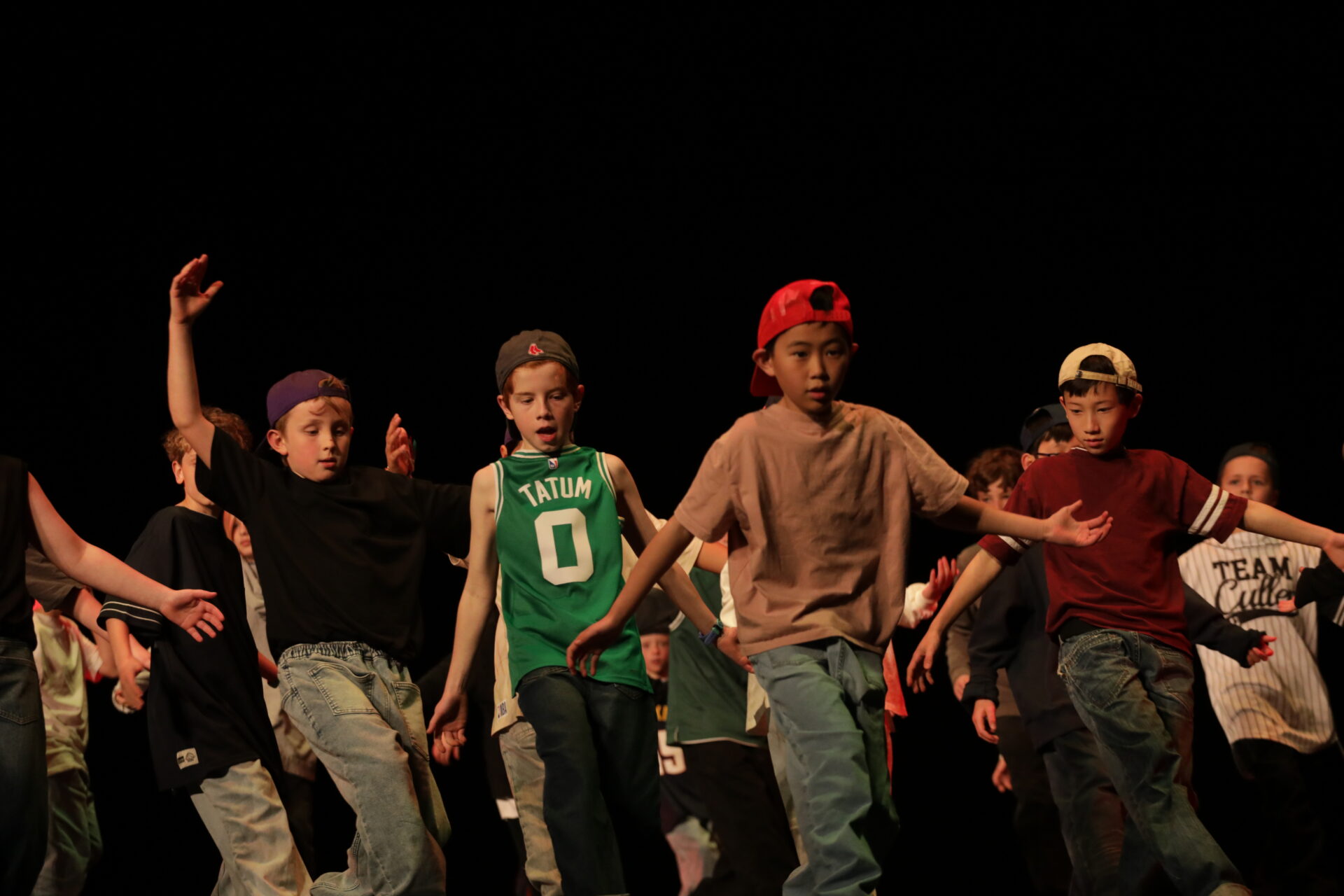 Boys dancing hip-hop on stage, performing with energy and focus in front of an audience