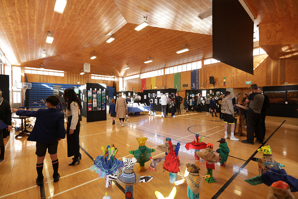Wellesley College Hall set up for an art exhibition, with artworks displayed and visitors viewing them